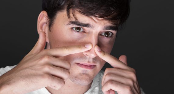 close-up-young-man-touching-nose